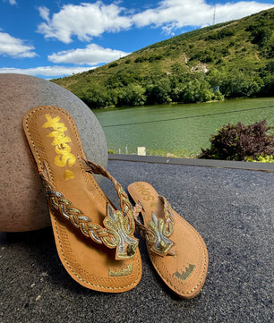 Noori handmade leather sandals by SOMA, styled outdoors by a lake
